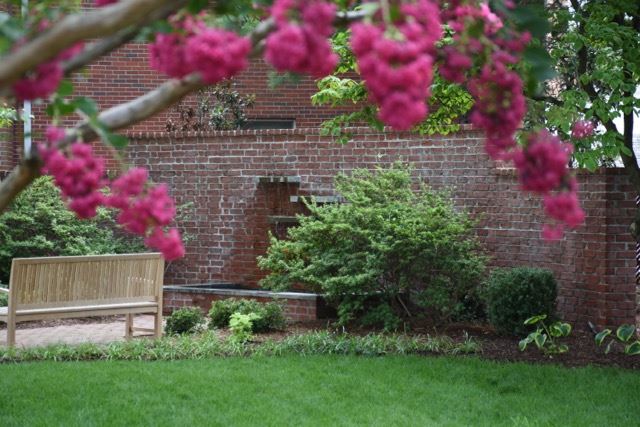 Fountain Coming off the Side of a Red Brick Wall